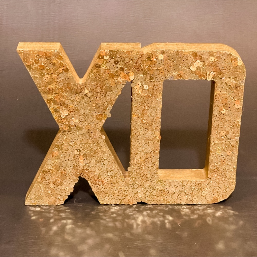 Gold XD sign with gold sequins